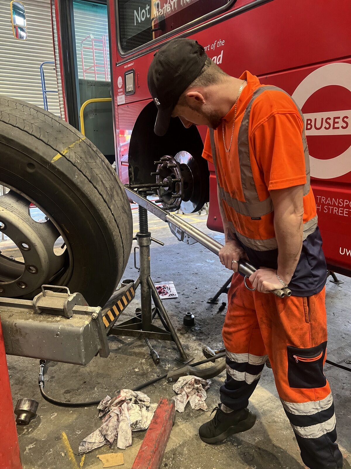 Jake Essex working on a London bus wheel