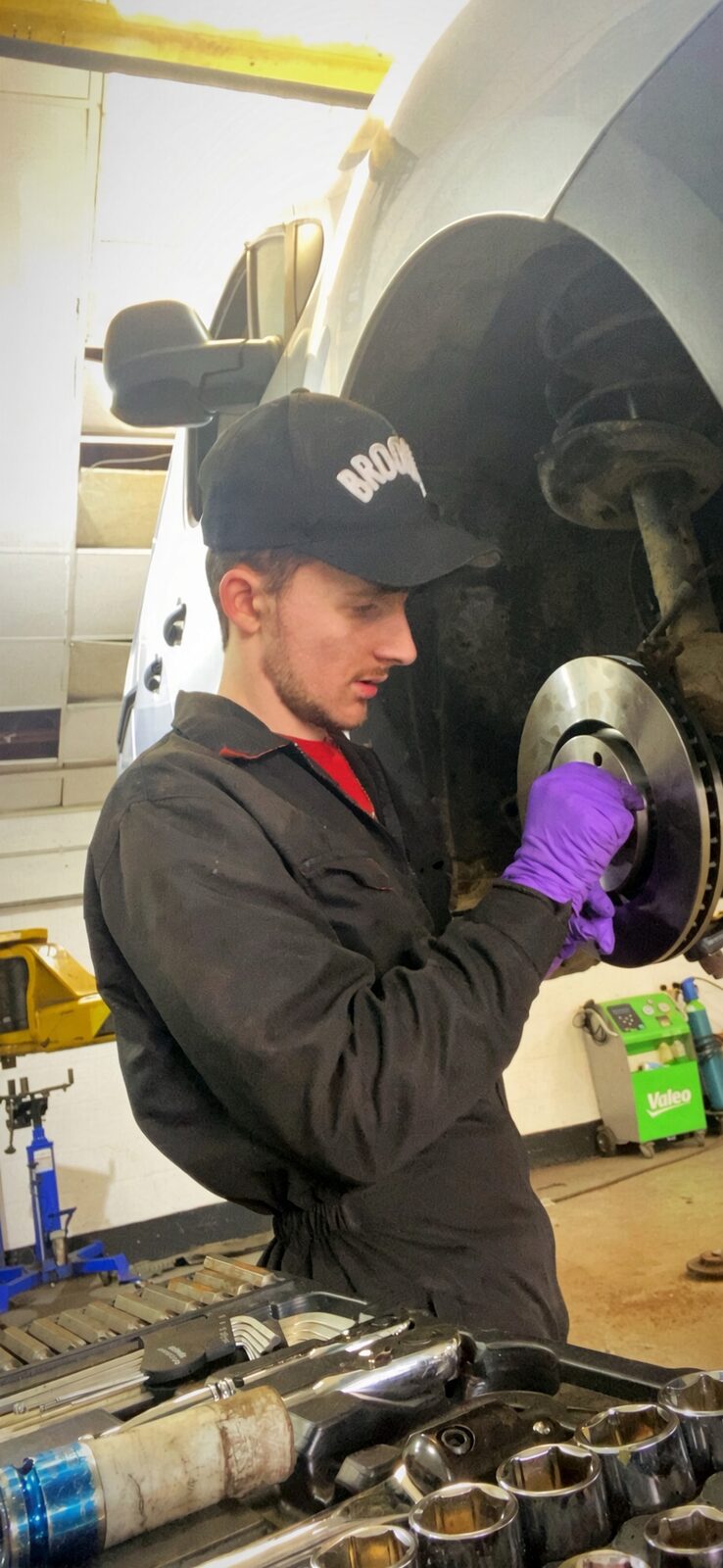Jake Essex fitting a brake disc in a London garage