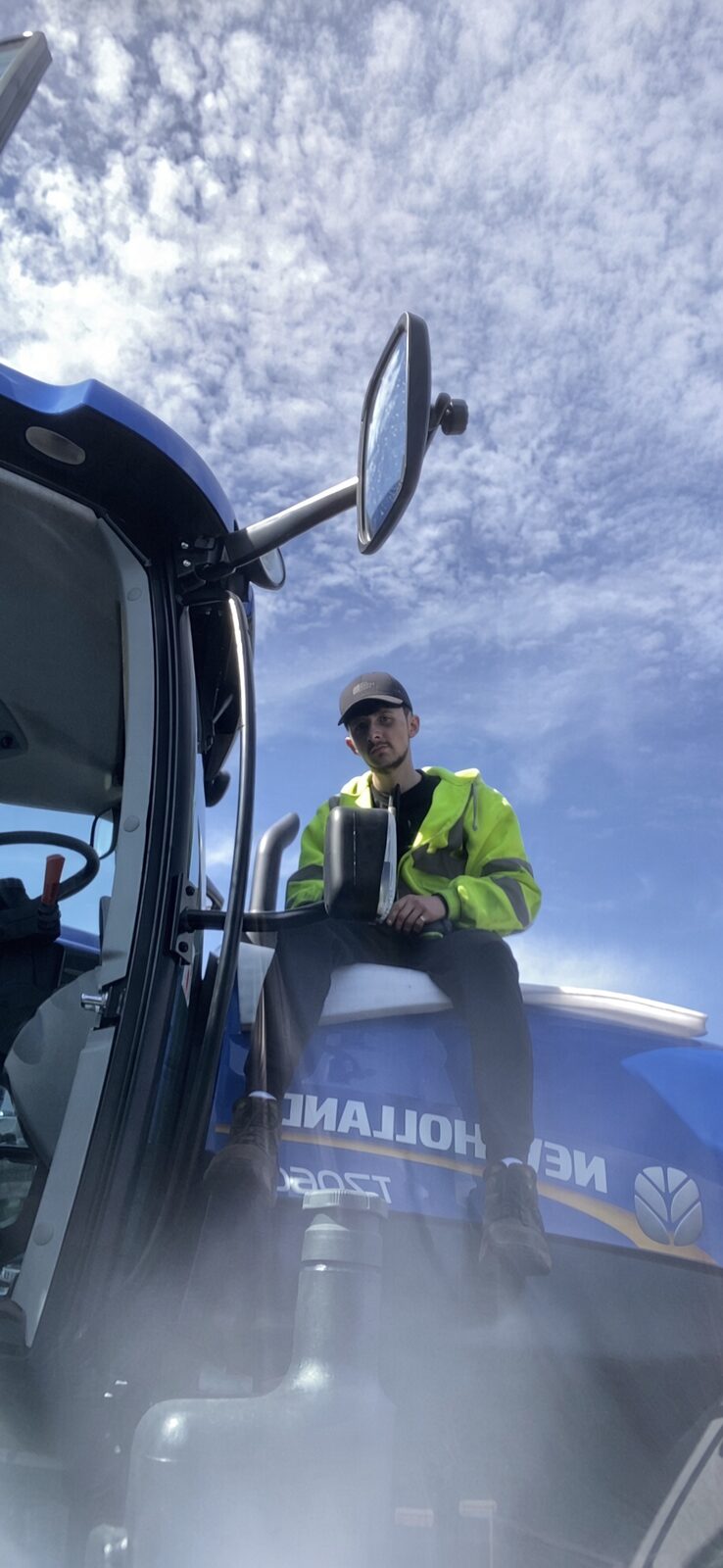 Jake Essex sitting on a New Holland tractor in Basildon